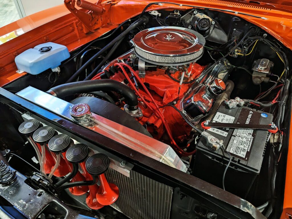 Detailed view of a vintage car engine showcasing components and intricate design.