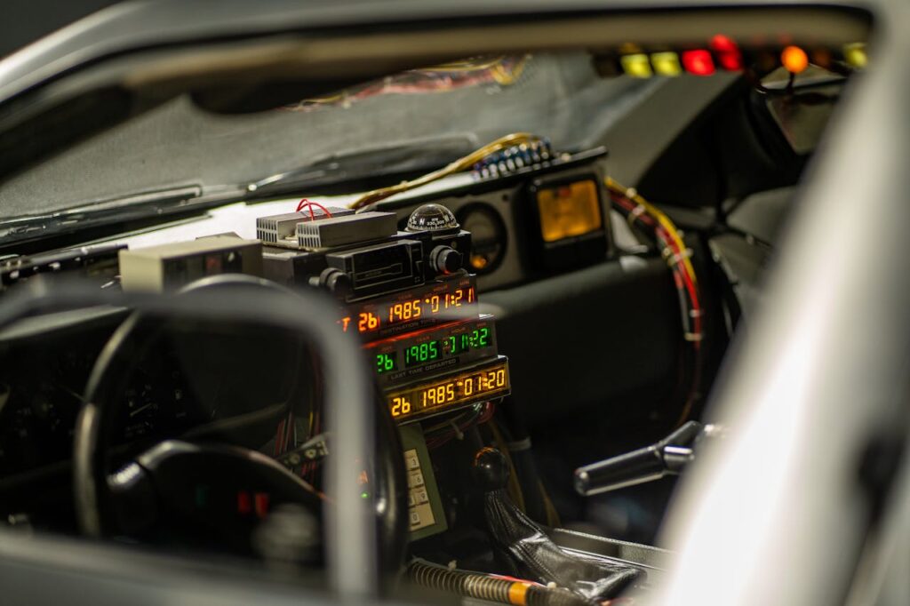 Close-up of a vehicle's cockpit showcasing a time-travel display with colorful lights and gadgets.